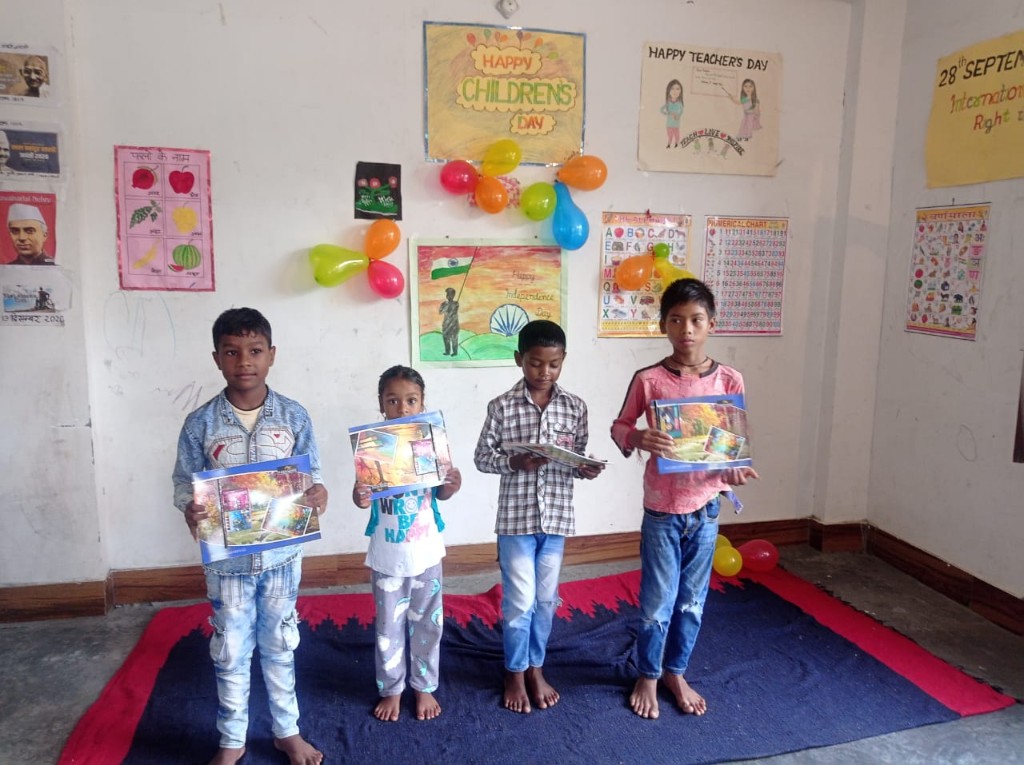 Boys at the Open Shelter Home holding their artwork